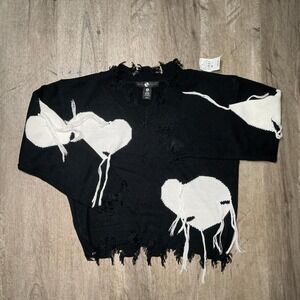 Black & white distressed sweater with fringe details. Size: S
